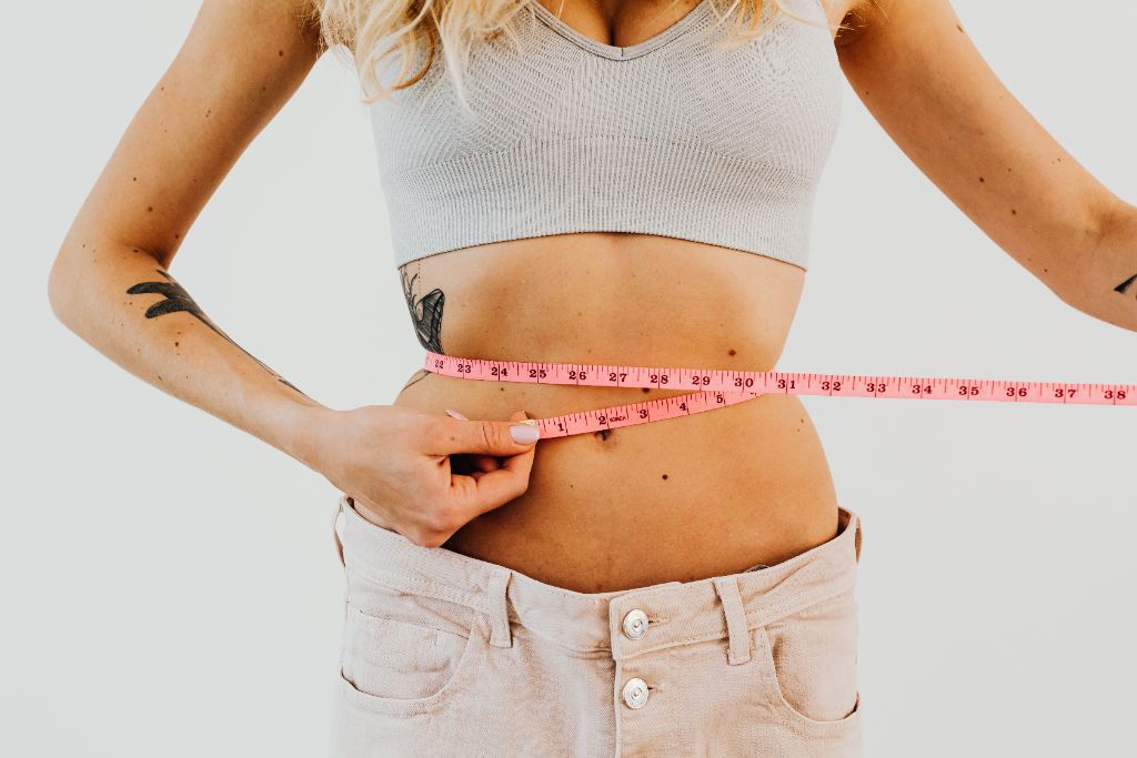 Person measuring their waist